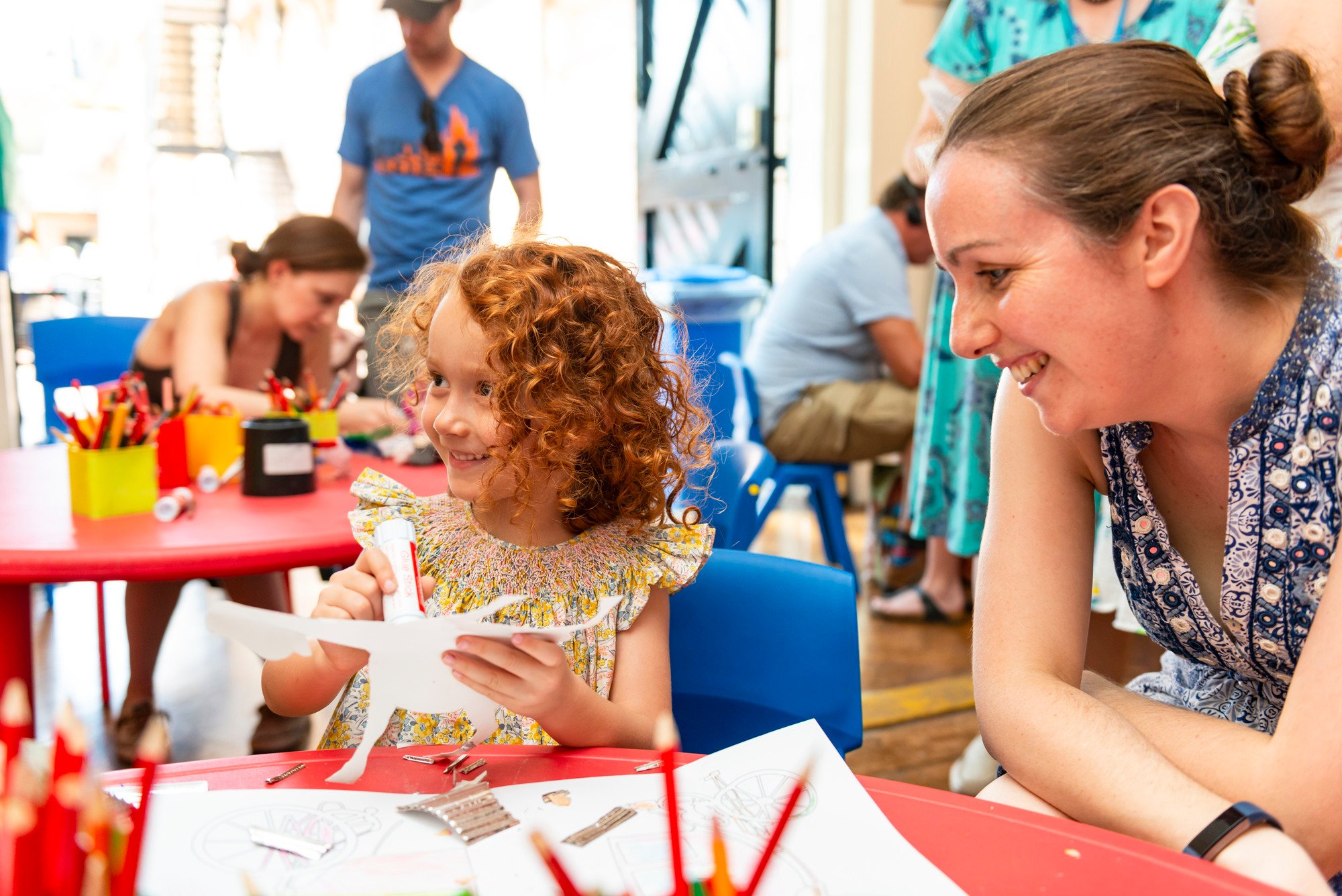 Child and a grown up doing a craft activity together