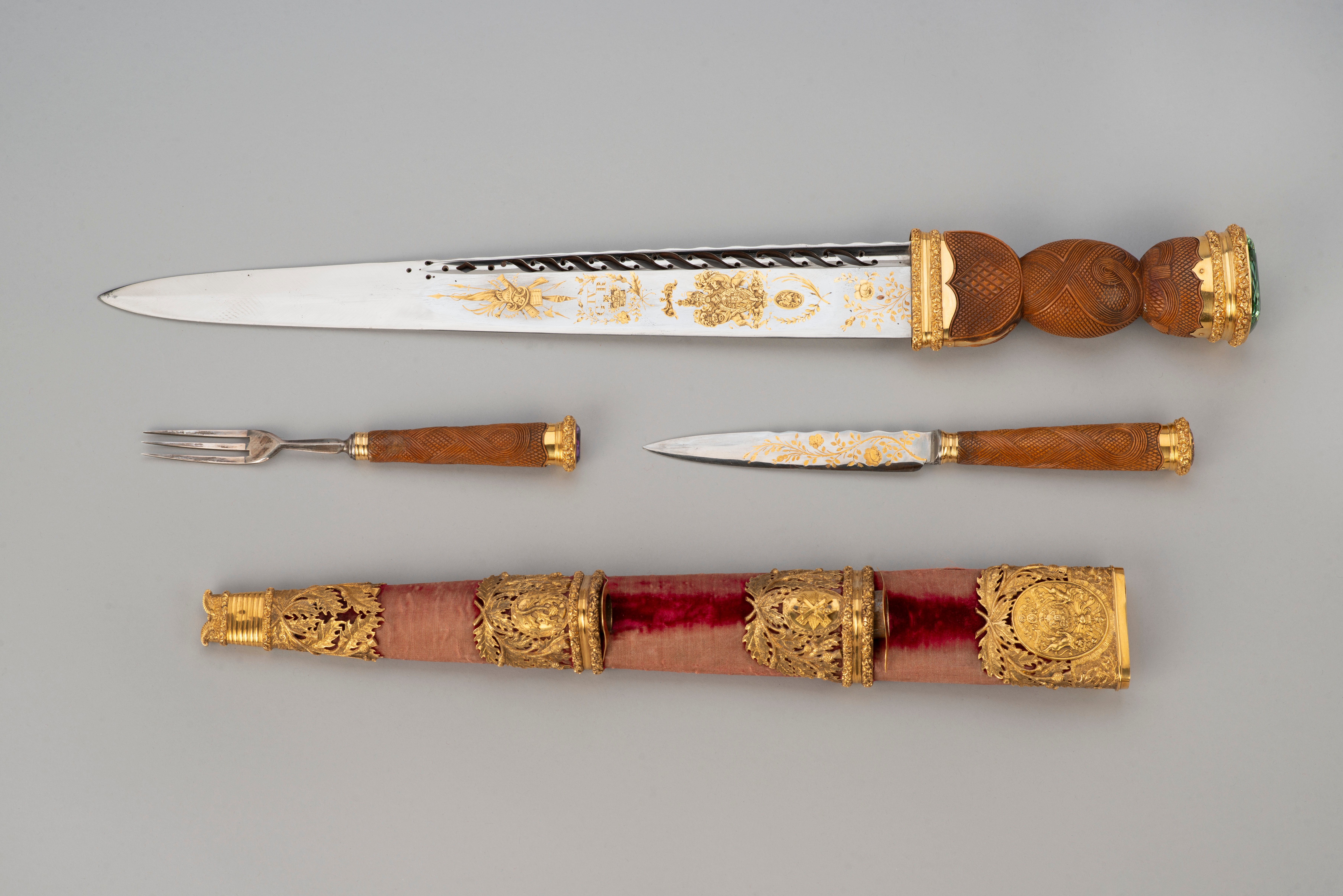 A blade with a scabbard covered in red silk