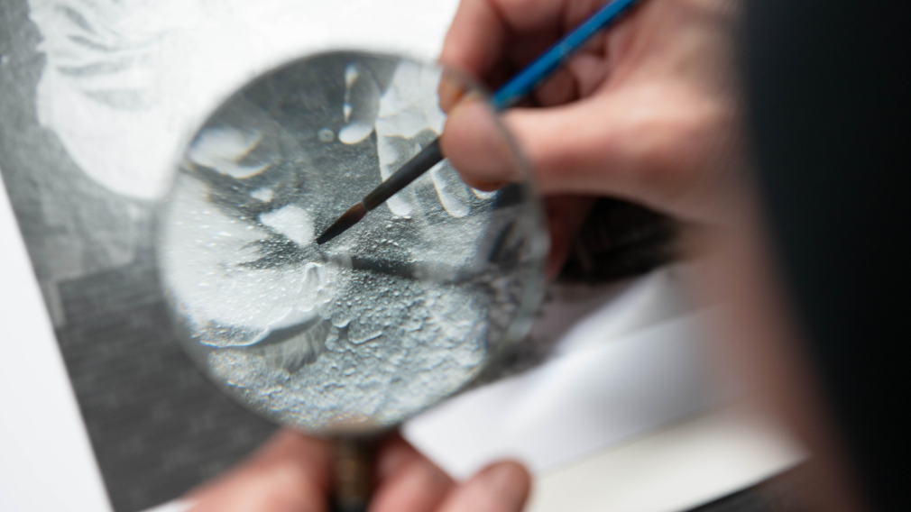 A contemporary professional practitioner retouching a modern photographic print A contemporary professional practitioner retouching a modern photographic print.