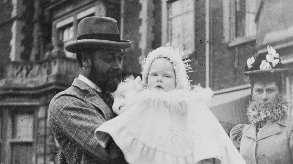 King George V holding his first son Prince Edward with Queen Mary