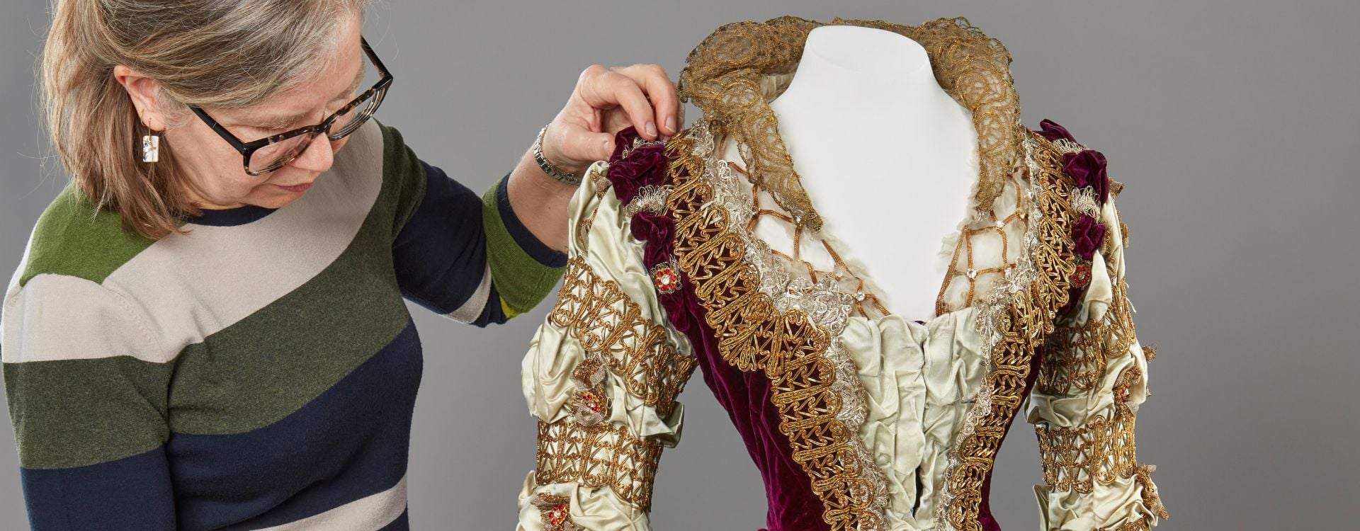 Queen Alexandra's Mary Queen of Scots fancy dress costume (RCIN 71875) A conservator with a purple and white dress.