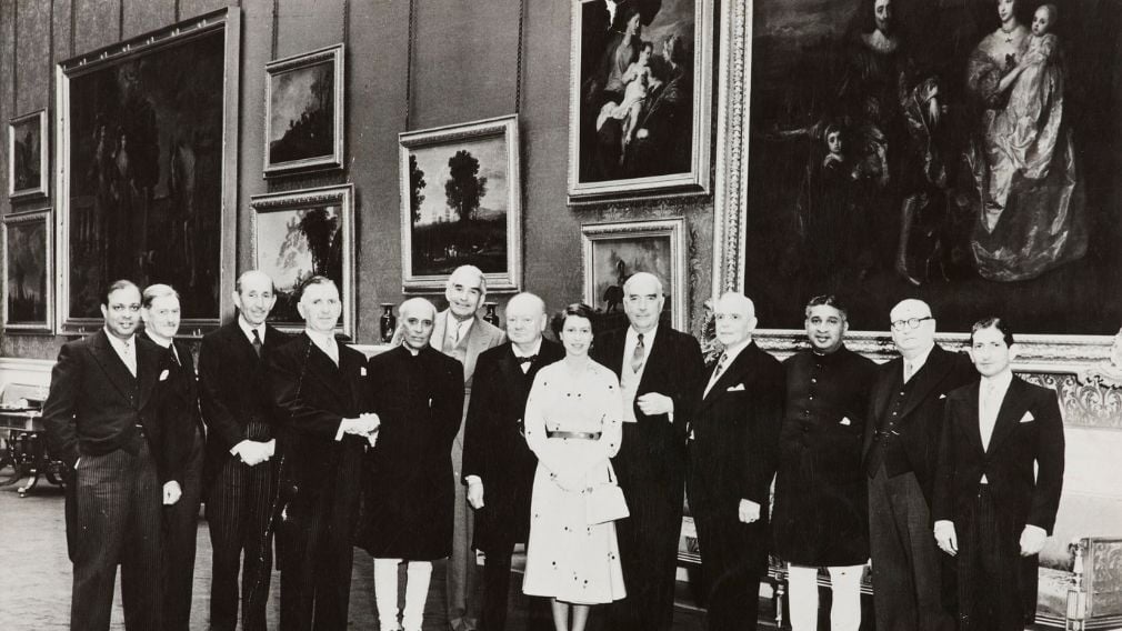 Queen Elizabeth II with her prime ministers, 1953 (RCIN 2007006) Black and white photograph of Queen Elizabeth II standing with her prime ministers. Behind them are paintings on the wall.