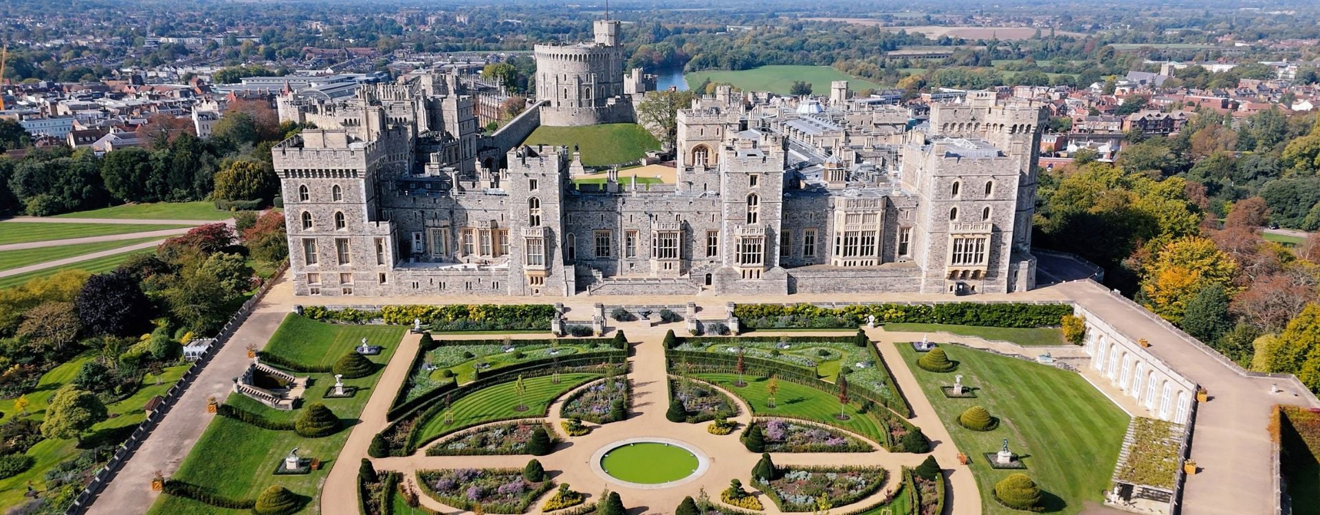 A garden with a castle in the background.