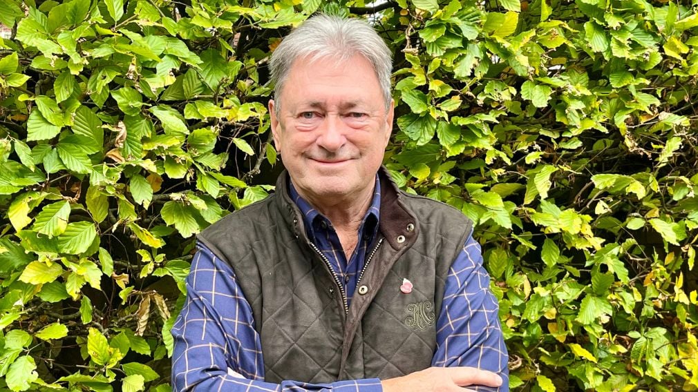 Alan Titchmarsh Photo of Alan Titchmarsh folding his arms in front of plant