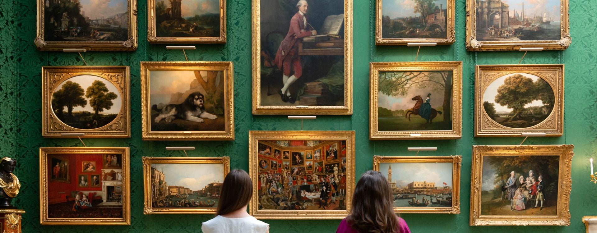 Picture Gallery at Buckingham Palace. Two people looking at paintings on a wall.