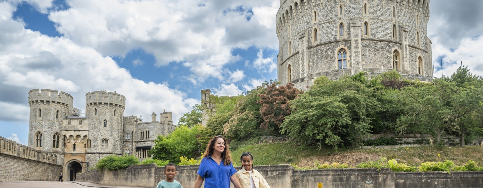 Visitors stroll through the Castle precincts. The Round Tower can be seen in the background.