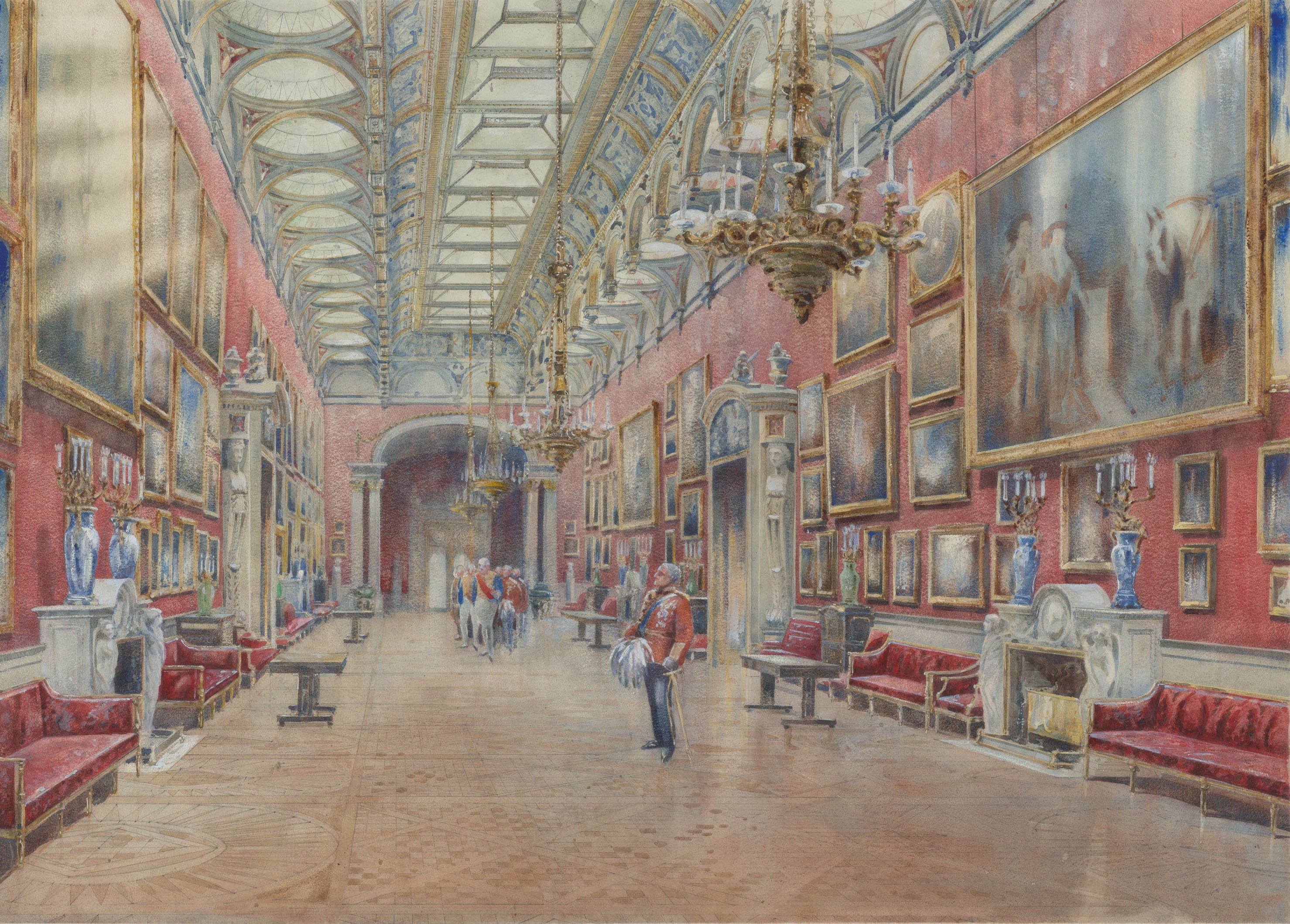 The Picture Gallery at Buckingham Palace c.1908/9 (RCIN 924592) A painting of a room with red walls and wooden flooring. Paintings hang on the wall.