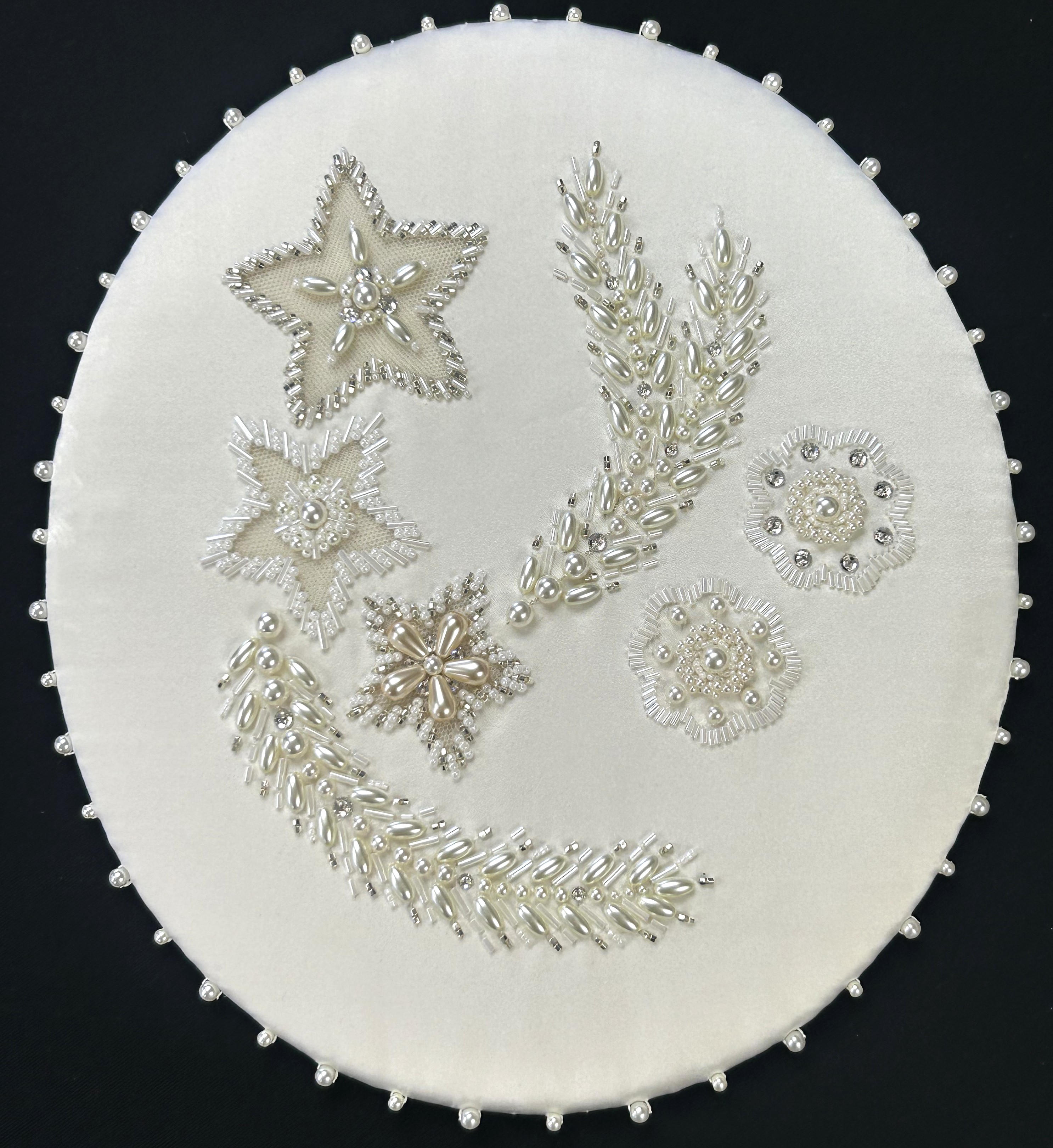 Embroidered motif designed by RSN tutor Claire de Waard, inspired by Queen Elizabeth II's Wedding Dress