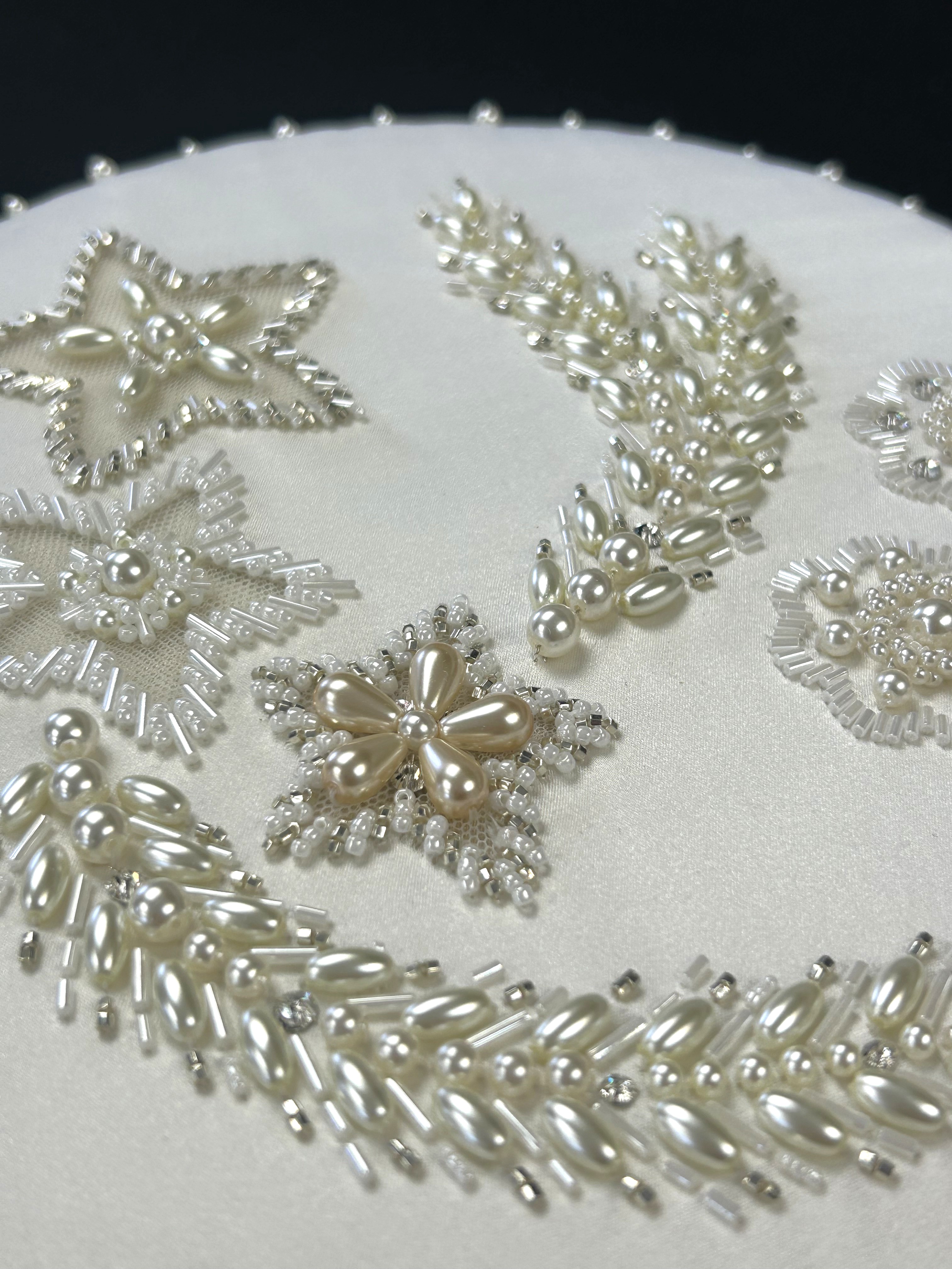 Embroidered motif designed by RSN tutor Claire de Waard, inspired by Queen Elizabeth II's Wedding Dress