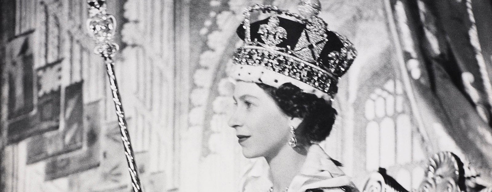 Photograph of Queen Elizabeth II wearing coronation robes and holding Coronation Regalia.