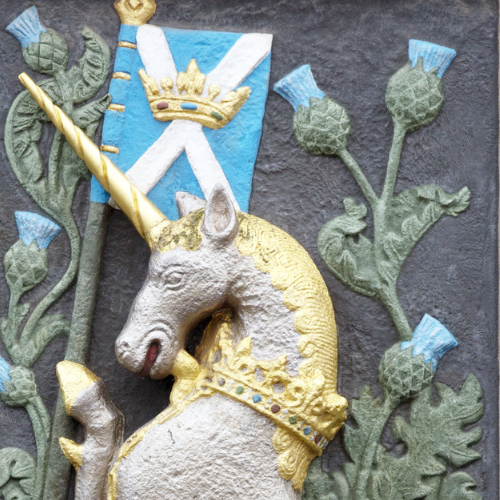 painted stone carving of a unicorn 