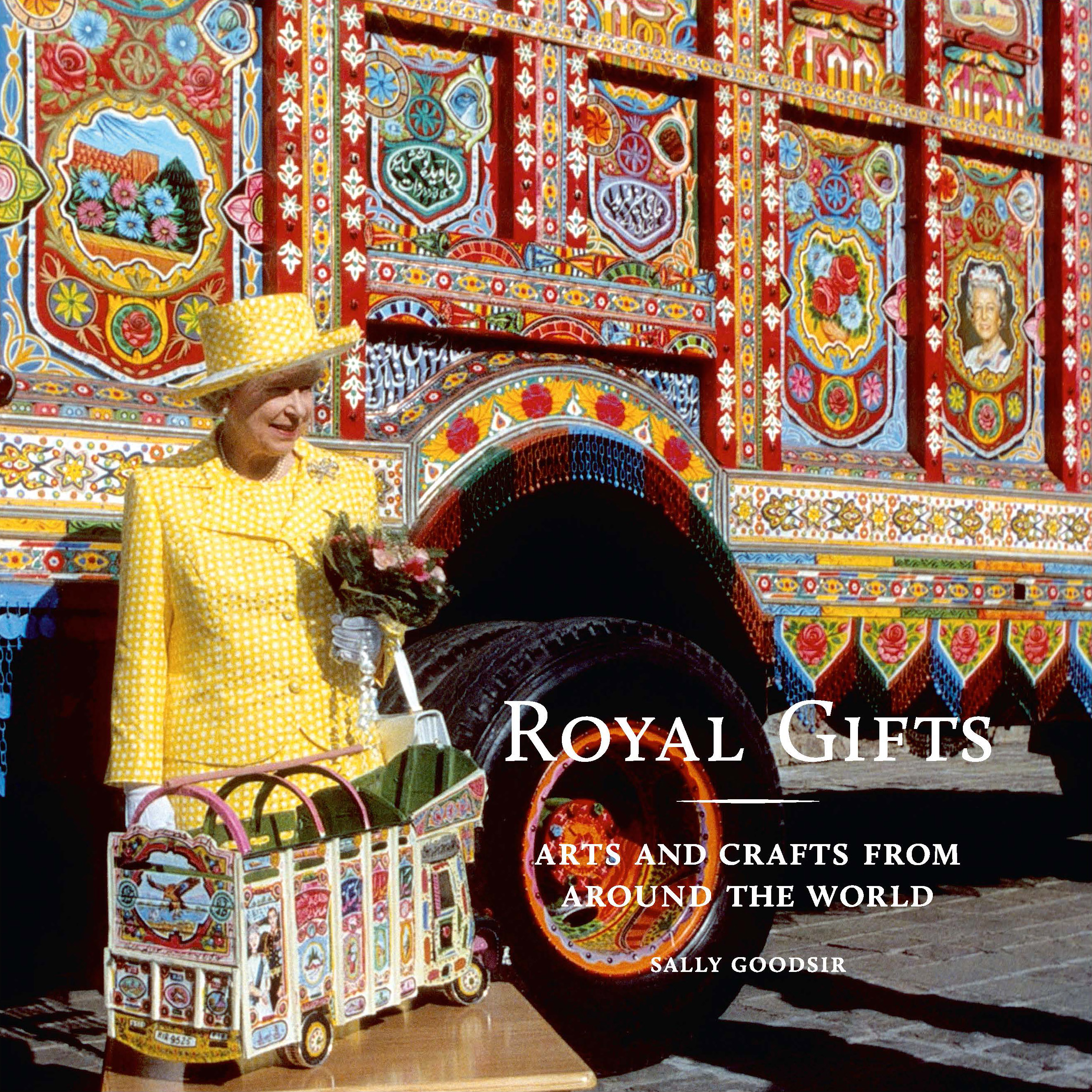 Cover of Royal Gifts Cover for the Royal Gifts catalogue, showing The Queen standing in front of a brightly painted book