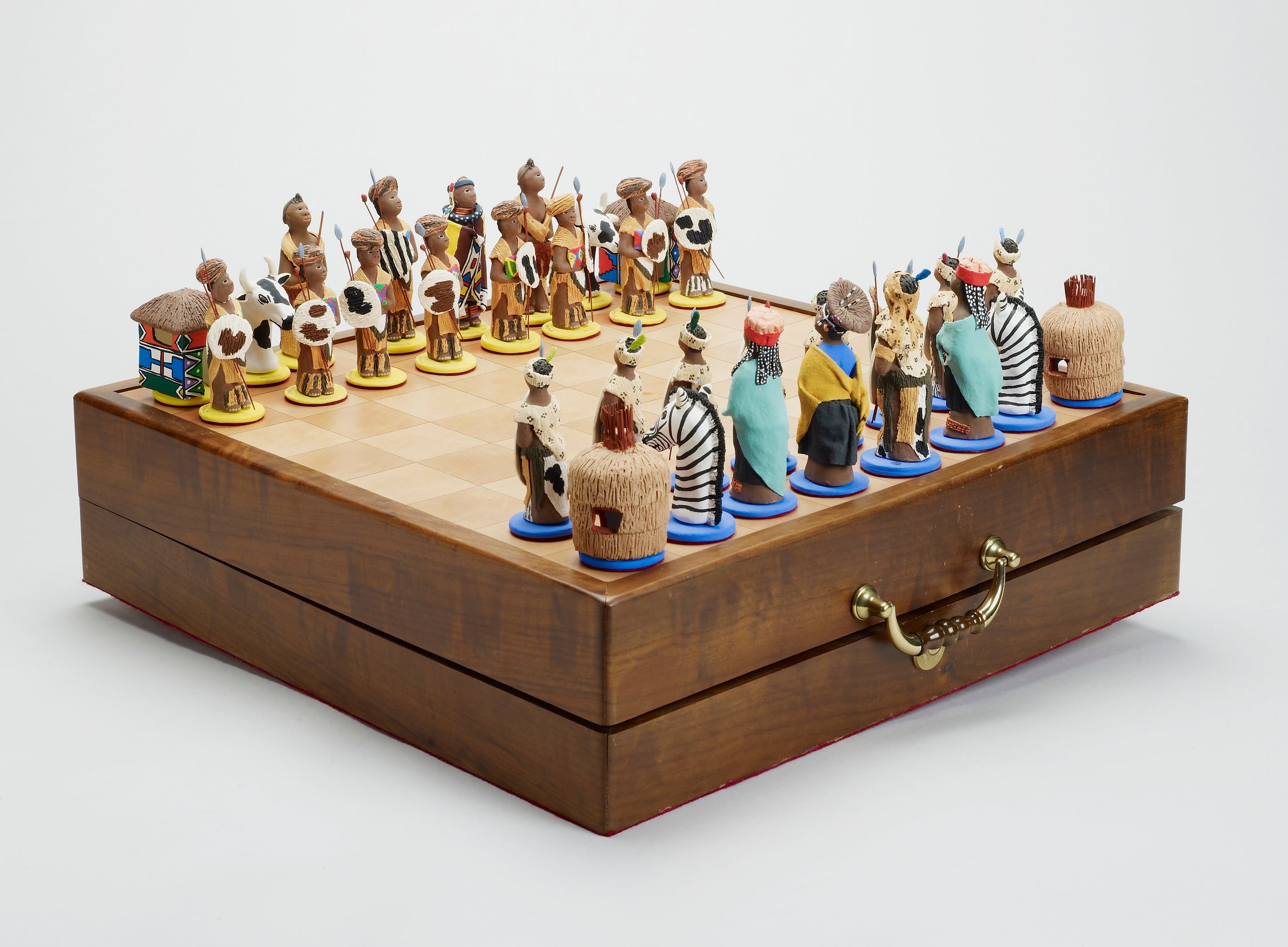 Chess set presented to Prince Philip, The Duke of Edinburgh by President Mandela. RCIN 99512. A chess set featuring pieces dressed in Zulu and Ndebele traditional costume