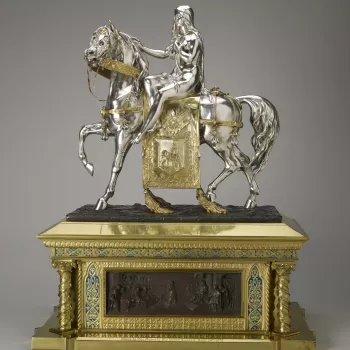 This figure of Lady Godiva was purchased by Queen Victoria and presented to Prince Albert on his birthday, 26 August 1857.

It was modelled by the French sculptor Pierre-Emile Jeannest, who worked for both Minton and Elkington. At the Great Exhibition h