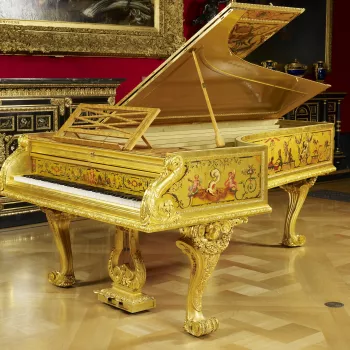 Grand piano with gilded and painted surface by Fran&ccedil;ois Rochard in polychrome colours with singeries and Berainesque motifs. Mouldings and rim of piano of bronze, chased and gilt. Supported on three incurving cabriole legs of gilded wood with heavy