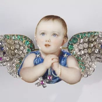Mounted in gold, the cut out enamel miniature of the Princess Royal clasping a string of pearls from which hangs a real diamond and ruby crucifix. She has bejewelled wings mounted at the shoulders. <br> 
<br>Queen Victoria's first child, also named Victor