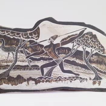 This slate plaque, in the stylised shape of the continent of Australia, depicts a hunting scene. It was presented to Queen Elizabeth II by Albert Barunga and his wife&nbsp;(c. 1910-1977) on the occasion of her Silver Jubilee in 1977.&nbsp;A Presbyterian m