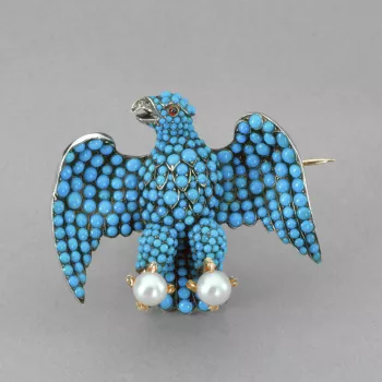 Eagle brooch of turquoise; ruby eye and diamond beak, the whole set in silver with gold claws holding pearls.
This is one of the brooches given to each of the twelve ladies - unmarried daughters of the nobility - who carried Queen Victoria's train at her 