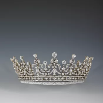 Tiara of diamonds and silver;  in two parts, both of which can be worn separately.   Of a scroll and festoon design in diamonds set on a detachable bandeau base of alternate circular and lozenge diamonds between two plain diamond bands.