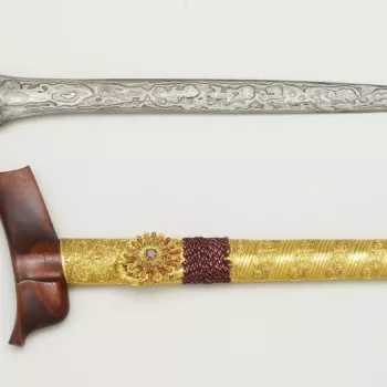 Sumatran kris and sheath. The pattern-welded iron blade is straight, with a dull pamir. The ivory hilt is of 'kingfisher' form, and is connected to the blade by a copper mendaq with a gold ring. The top of the wooden scabbard (wrangka) is plain, and the l