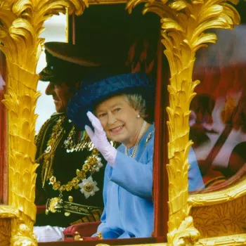 Photograph of HM The Queen (b.1926) and HRH The Duke of Edinburgh (b.1921) waving from the Gold State Coach en route to St.Paul's Cathedral for the Golden Jubilee Thanksgiving Service, 4th June 2002.  Used as a christmas card.

