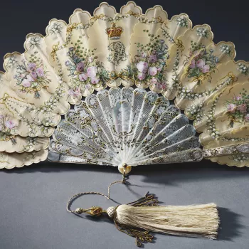 Fans of this form were popular in Europe from the mid-nineteenth century. In these fans, which may derive from Chinese painted feather fans, the decoration continues from leaf to leaf. In the present case the decoration includes the emblems of the British