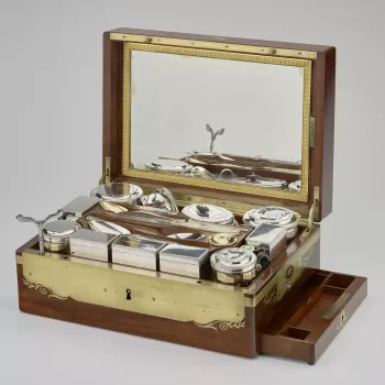 A silver and silver-gilt travelling service in a mahogany and brass-bound box, the lid inset with a brass shield engraved with the SN monogram of St&eacute;phanie Napoleon (Stephanie&nbsp;de Beauharnais).&nbsp;The box has&nbsp;brass carrying handles and i