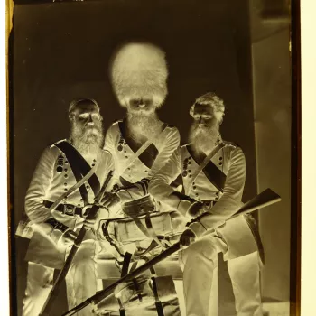 10" x 8" glass plate negative showing three soldiers&nbsp;from the Coldstream Guards who served in the Crimean War. From&nbsp;right to&nbsp;left are&nbsp;Joseph Numa, John Potter and James Deal. Potter is&nbsp;standing&nbsp;behind a wooden&nbsp;table wear