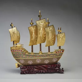 This is a model of the treasure ship sailed by the navigator and diplomat Zeng He of the Ming Dynasty. The prow of the ship is decorated with a dove and olive branch medallion, emblematic of peace, whilst the sides of the hull are decorated with elements 