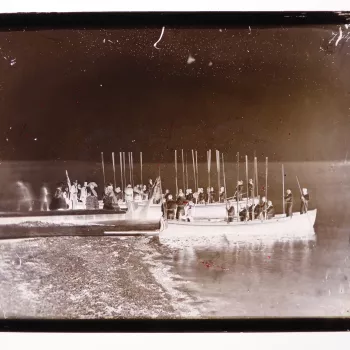 Glass plate negative of Napoleon III (1808-73) and Eug&eacute;nie de Montijo, then Empress Consort of the French (1826-1920) boarding a boat off a jetty. There are three boats around the jetty. Men on the boats hold up their oars. Photograph taken at Osbo