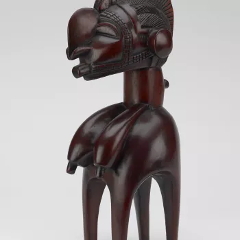A carved wooden model headdress or Nimba, of the d'mba form found among the Baga people of Guinea.
In the form of a stylised female, with four slender legs, pendulous breasts and an enlarged head with a long pointed nose and protruding chin.
Headdresses o