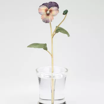 A single pansy with bud, enamelled with opaque violet and with a brilliant diamond centre, two nephrite leaves are attached to the green gold stalk, all set in a rock crystal pot. 
The pansy was almost as popular as the philadelphus in Russia, flowering i