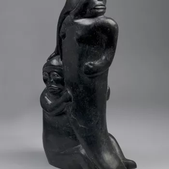 A&nbsp;serpentinite carving&nbsp;of an female figure with the tail of a fish, her head turned&nbsp;to&nbsp;her left,&nbsp;with long hair flowing down her back and a child holding on to her waist.<br /><br />The sculpture may depict Sedna, the Inuit goddes