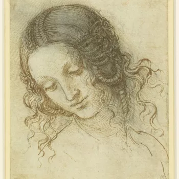 A drawing of the head of a woman turned three quarters to the left, looking down. The hair is fastened in elaborate braids, and arranged in coils over the ears. This is a study for the head of Leda in the lost painting of Leda and the Swan.&nbsp;Melzi's n