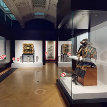 Gallery space with exhibition objects in glass cases 