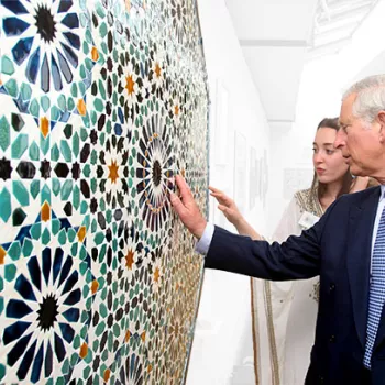 Prince Charles discusses an artwork with a student