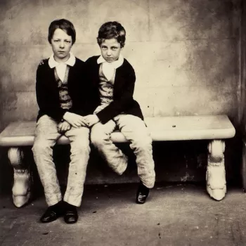 Photograph of two boys, the Comte d'Eu and Duc D'Alencon, sat on a stone bench