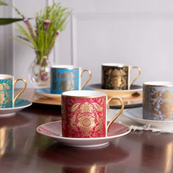 A selection of coffee cups and saucers in pink, black, teal, blue and greywhite