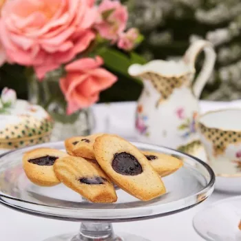 Image of cherry madeleines on a decorated table