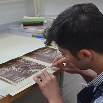 Conservator working on the photograph albums.