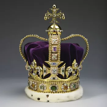 A gold crown set diamonds, rubies, amethysts and sapphires. It has a purple velvet cap.