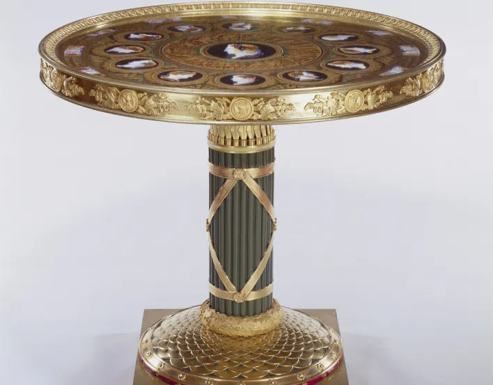 Centre table with circular S&egrave;vres porcelain top with chased gilt bronze mounts, stem-fasces; painted in imitation of classical cameos. In the centre is the head of Alexander the Great, surrounded by an outer circle of heads of twelve commanders fro