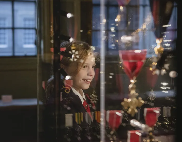 Child looking at medals