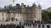 The Palace of Holyroodhouse exterior with parade of people in front