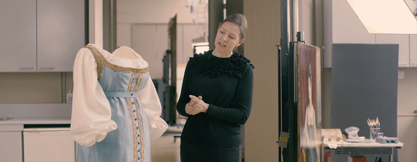 Conservators work on the dress and the portrait of Princess Charlotte in which she is wearing it